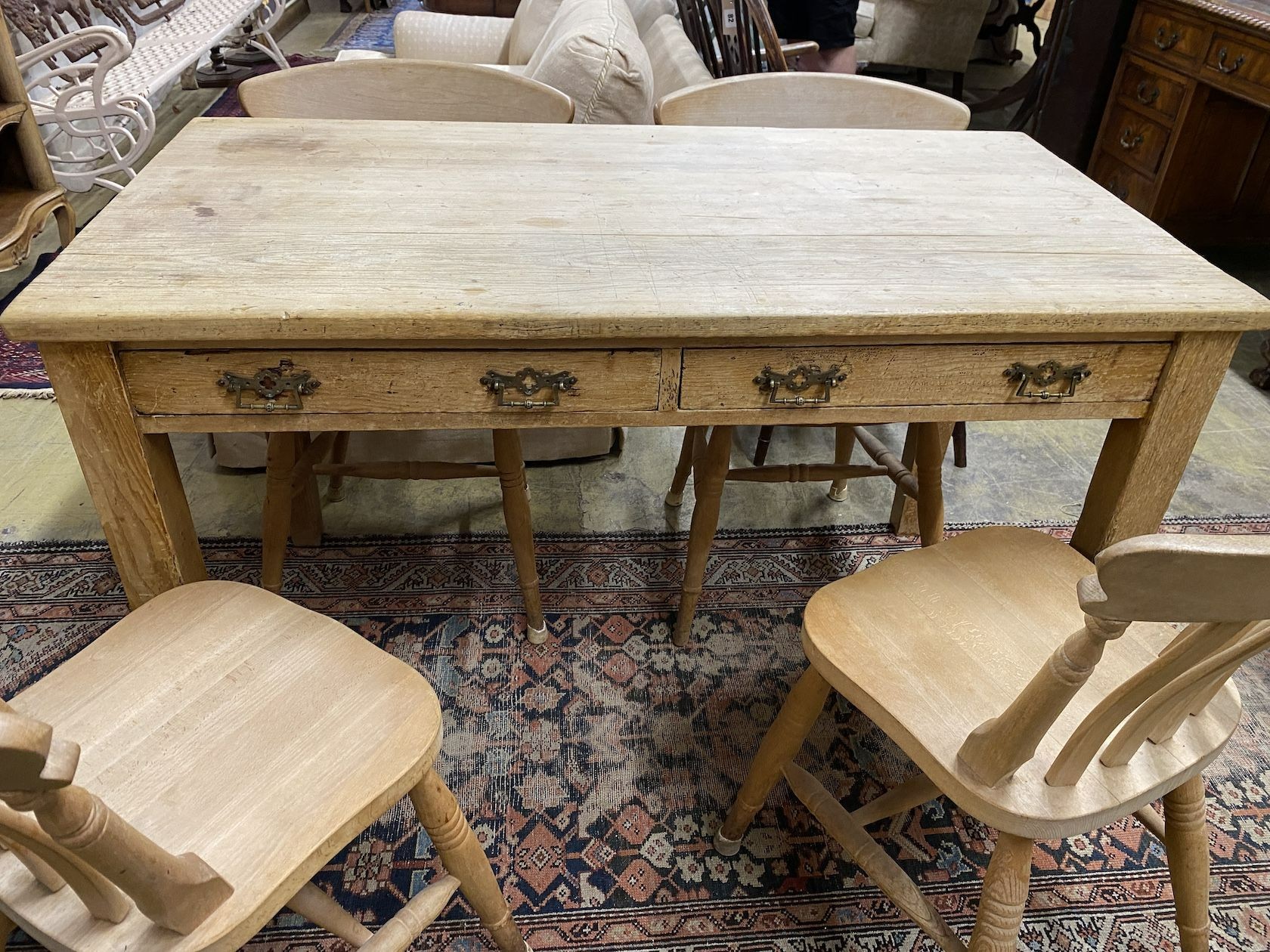 A Victorian pine two drawer kitchen table, width 30cm, depth 67cm, height 79cm together with four Victorian style Windsor beech lathe back kitchen chairs